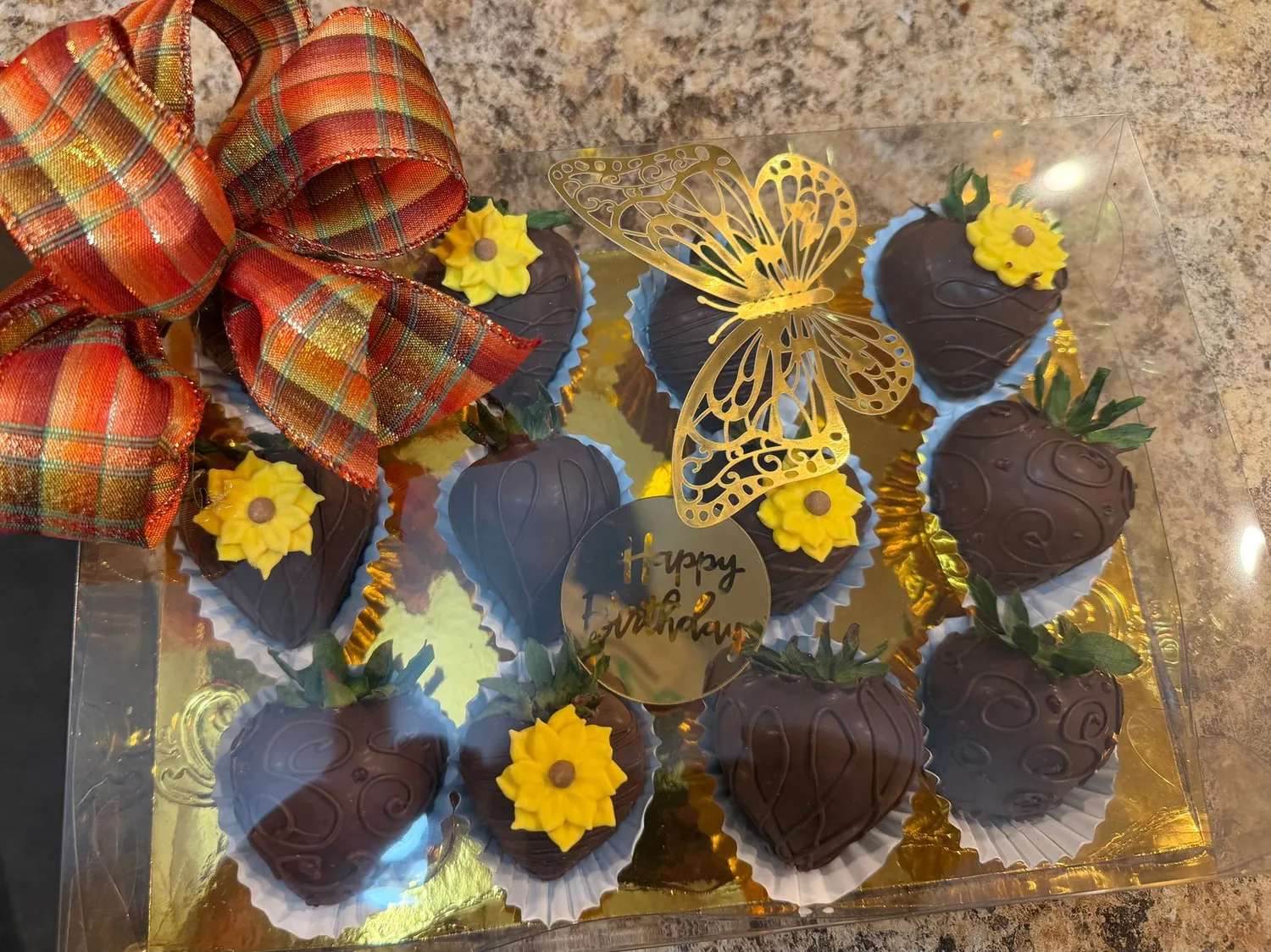 A dozen chocolate-covered strawberries in the clear gift box